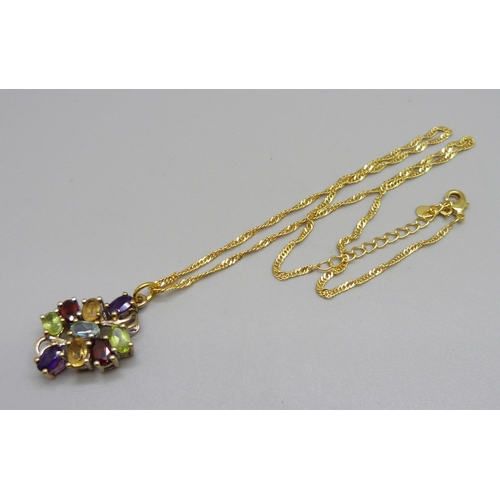 944 - A silver gilt multi-gem set pendant on a chain