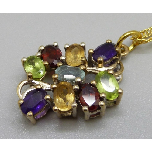 944 - A silver gilt multi-gem set pendant on a chain