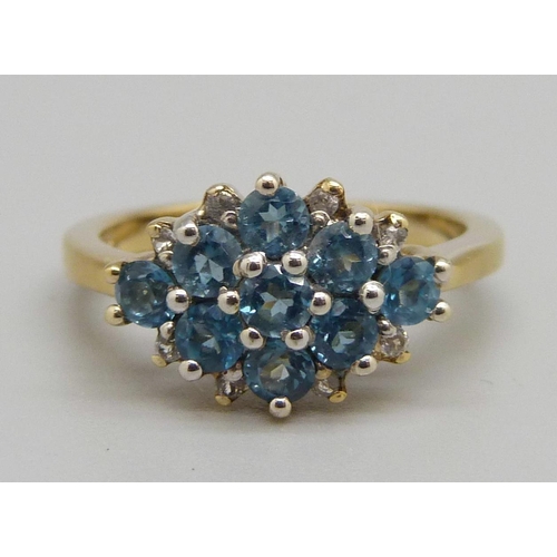 961 - A silver gilt blue stone cluster ring, O