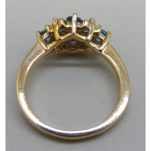 961 - A silver gilt blue stone cluster ring, O