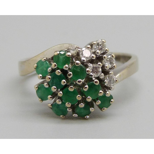 962 - An 18ct white gold, emerald and diamond ring, 5g, O