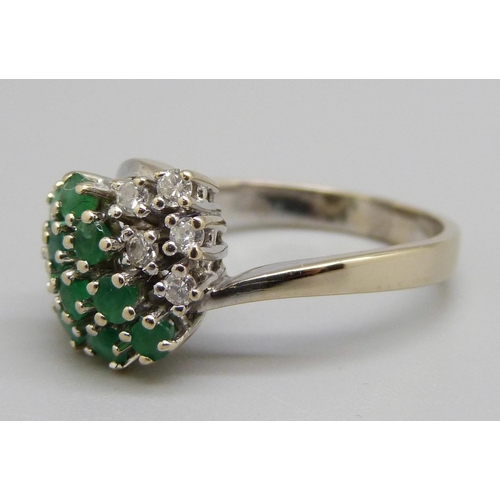 962 - An 18ct white gold, emerald and diamond ring, 5g, O