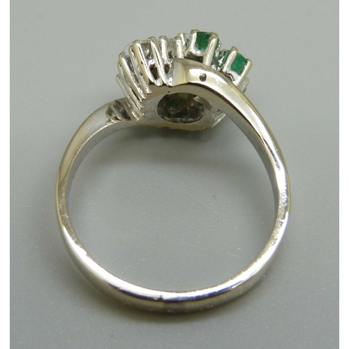 962 - An 18ct white gold, emerald and diamond ring, 5g, O