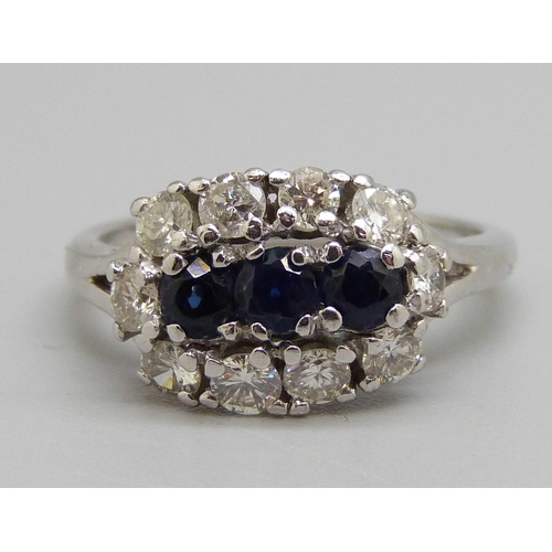 982 - An 18ct white gold, sapphire and diamond ring, 0.80ct diamond weight, 5.2g, N