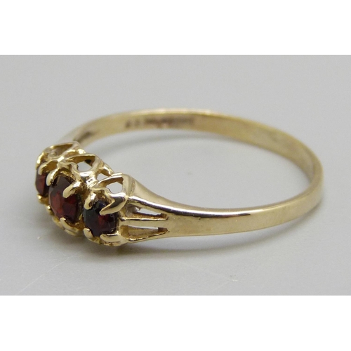 985 - A 9ct gold three stone garnet ring, 1.1g, O