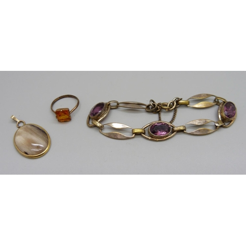 991 - A rolled gold bracelet, a ring and a pendant