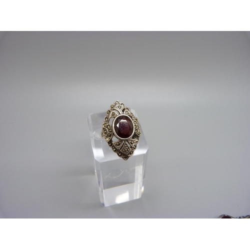 998 - A large silver and garnet ring, M, and a silver andgarnet bracelet