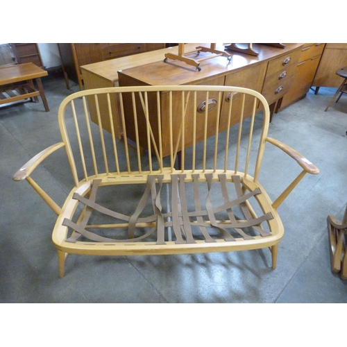 104 - An Ercol Blonde beech Windsor settee