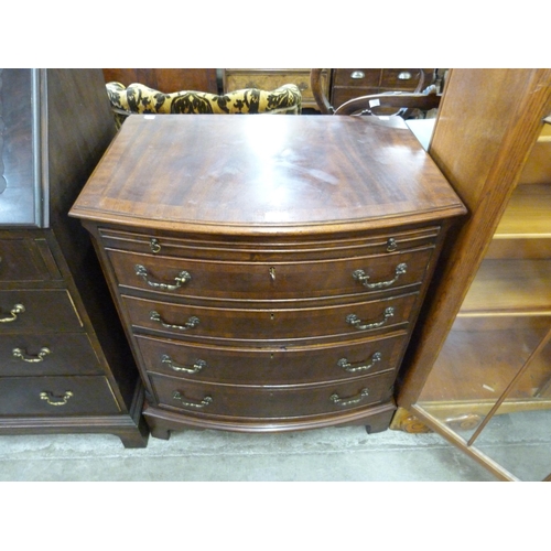 110 - A George III style mahogany bow front bachelors chest of drawers