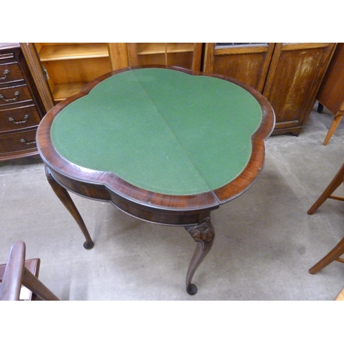 113 - An Edward VII mahogany fold over trefoil shaped games table