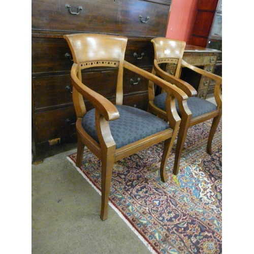 12 - A pair of Arts and Crafts style mahogany elbow chairs