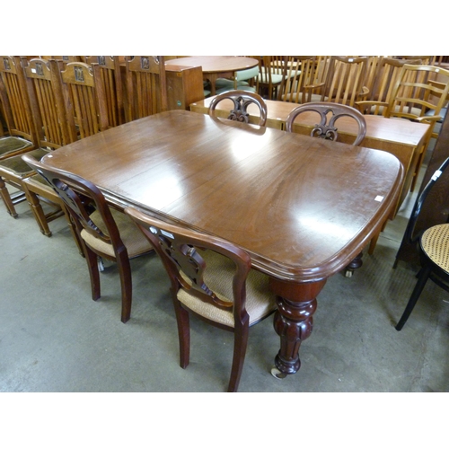 144 - A Victorian mahogany extending dining table and four chairs