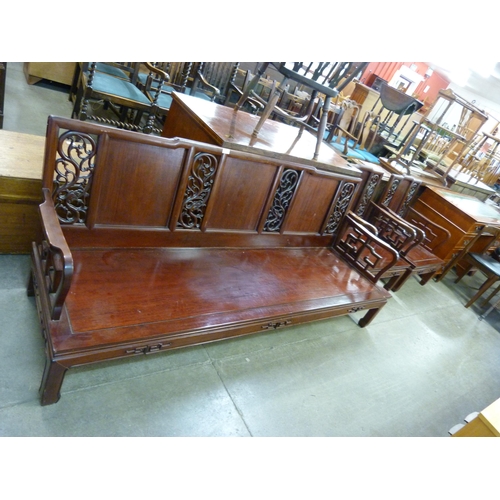 181 - A Chinese carved hardwood three piece suite, comprising settee and a pair of armchairs