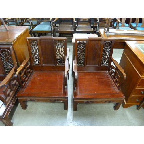 181 - A Chinese carved hardwood three piece suite, comprising settee and a pair of armchairs