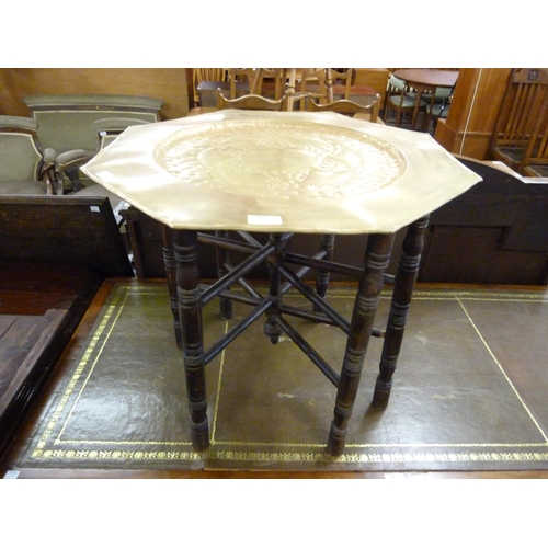 187 - An Eastern brass topped folding occasional table