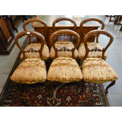 20 - A set of six Victorian carved walnut balloon back dining chairs
