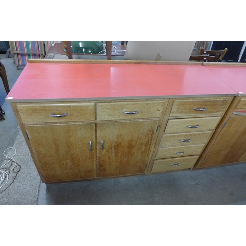 212 - A pair of mid 20th Century light oak and laminated top kitchen cabinets