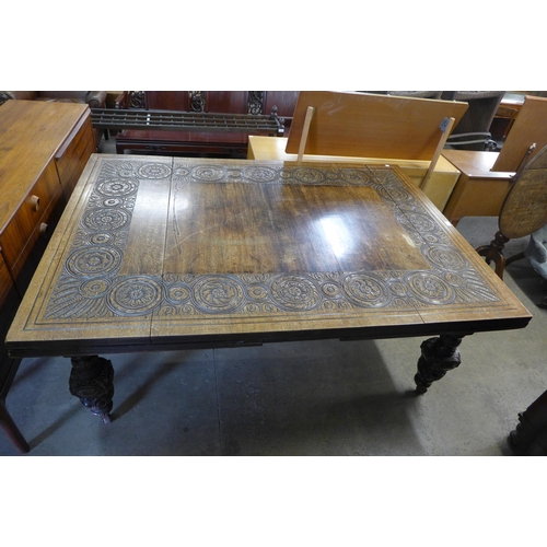 223 - A Victorian carved oak extending dining table, 73cms h, 181cms l (345cms l extended), 130cms w