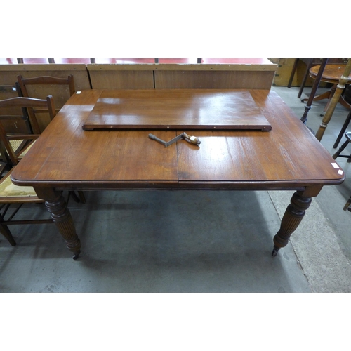 230 - A Victorian walnut extending dining table