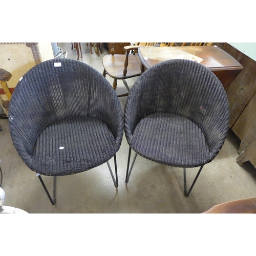 239 - A pair of metal and wicker chairs