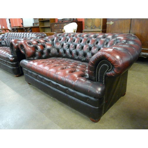 25 - An oxblood red leather Chesterfield settee