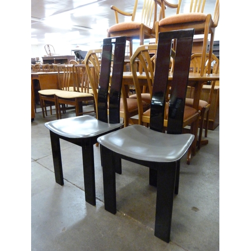 73 - A pair of Italian black high gloss chairs, manner of Pietro Costantini