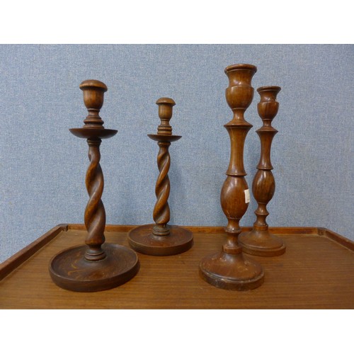 359 - A pair of Edward VII mahogany candlesticks and a pair of oak barleytwist candlesticks