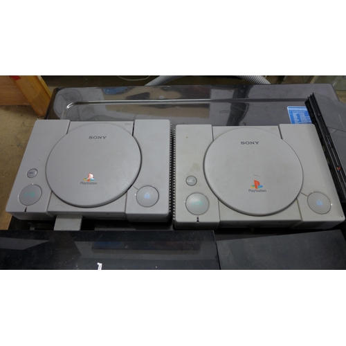 2231 - 2 PS1 Playstation consoles, PS2 consoles and a PS3 console plus leads, controllers and approx.28 mix... 