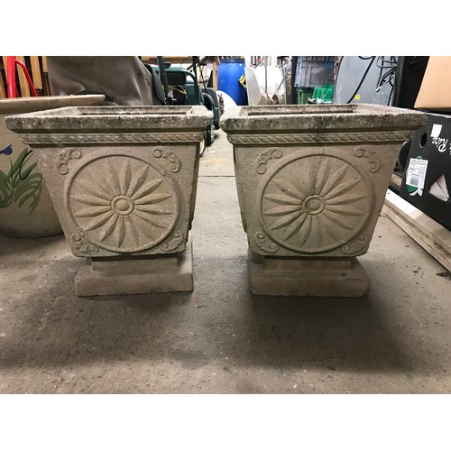 2314 - Pair of decorative square stone planters, approx. 1ft square and 15” tall on stone plinths