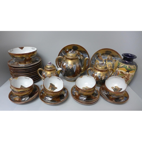 1017 - A Japanese satsuma tea set, eight cups, saucers, eleven tea plates, bowl, tea pot, cream and sugar, ... 