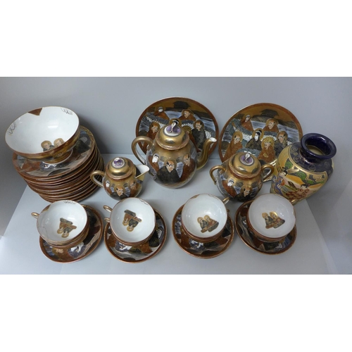 1017 - A Japanese satsuma tea set, eight cups, saucers, eleven tea plates, bowl, tea pot, cream and sugar, ... 