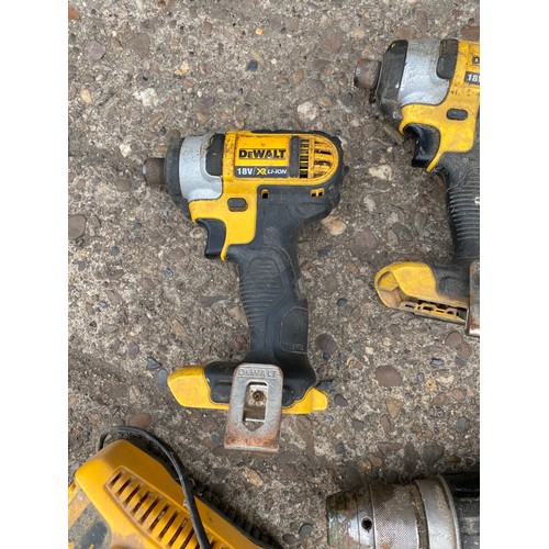 2028 - Three Dewalt impact drivers with Dewalt drill and charger