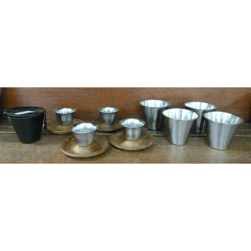 615 - Four Scandinavian style egg cups and a travel set of four cups