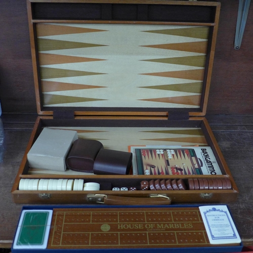 680 - A cased Backgammon set and a Cribbage set, boxed