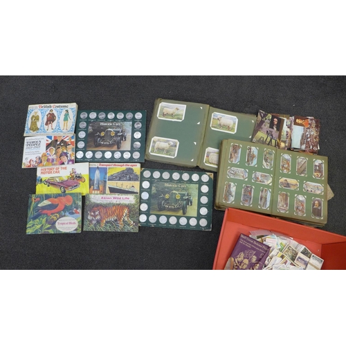 683 - A collection of cigarette cards, some early 20th Century, Historic car tokens, tea cards, etc.