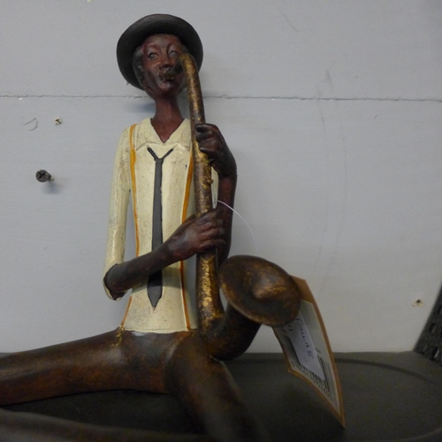 1314 - A sitting jazz band saxophonist, H 38cms (026012)   #