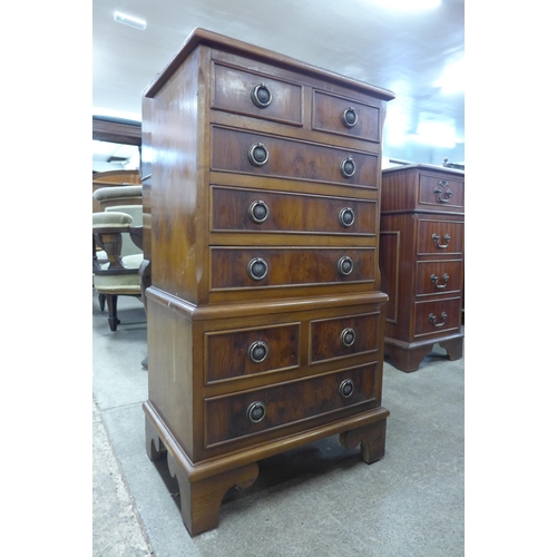 104 - A small yew chest on chest of drawers