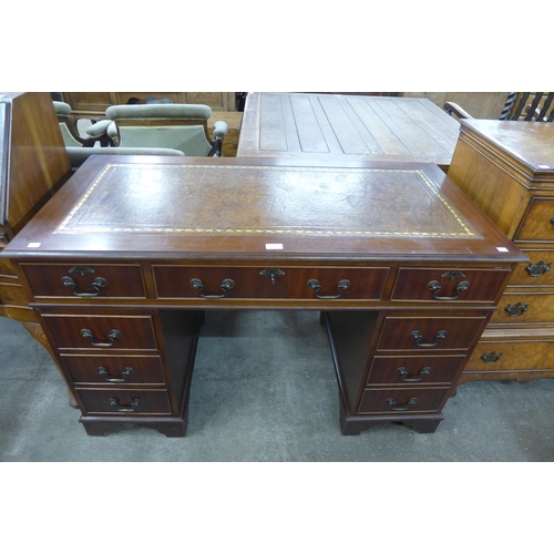 105 - A mahogany and leather topped pedestal desk