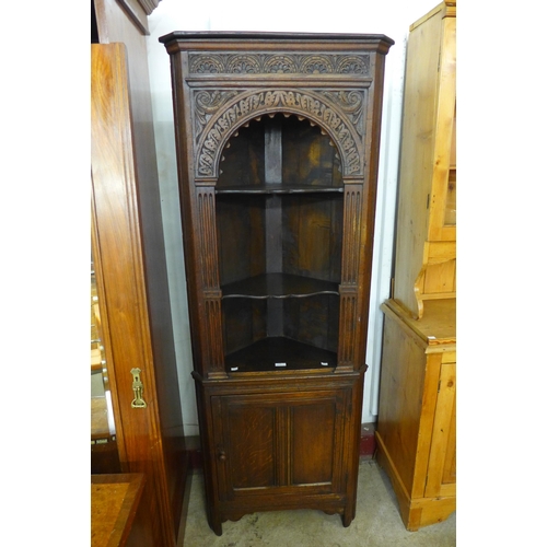 110 - A carved Ipswich oak freestanding corner cabinet