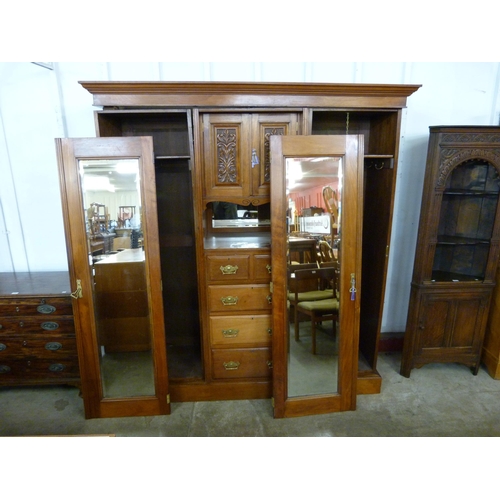 111 - A Victorian carved walnut combination wardrobe, a/f