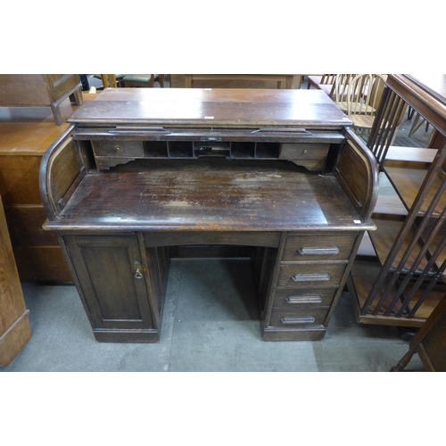 114 - An early 20th Century oak tambour roll top desk