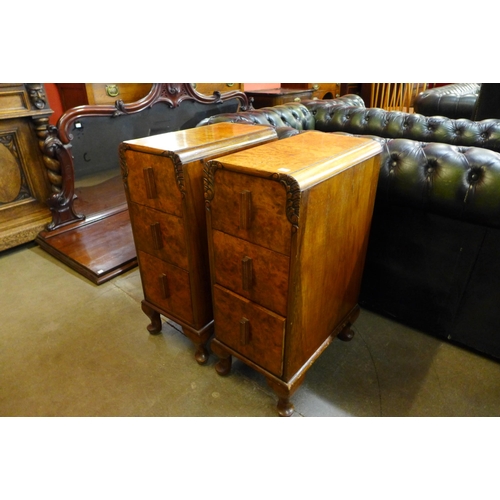 23 - A pair of Art Deco figured walnut pedestal chests