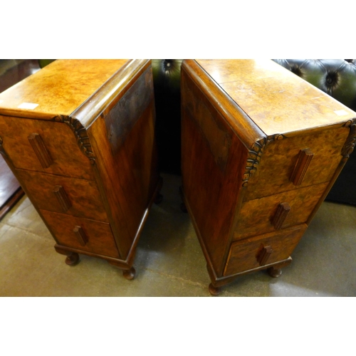 23 - A pair of Art Deco figured walnut pedestal chests