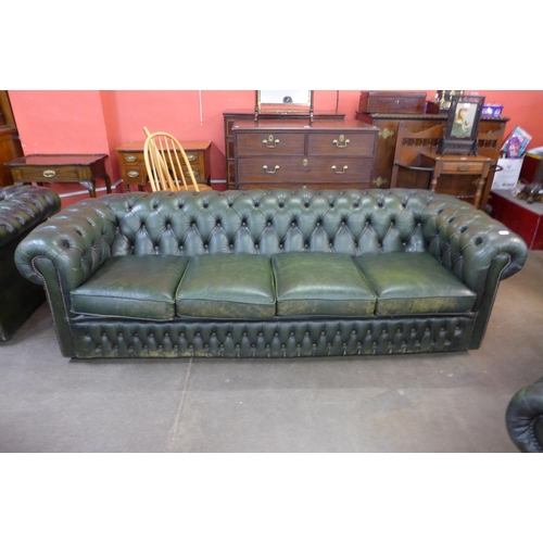 26 - A green leather Chesterfield three piece suite, comprising; four seater settee and two club chairs