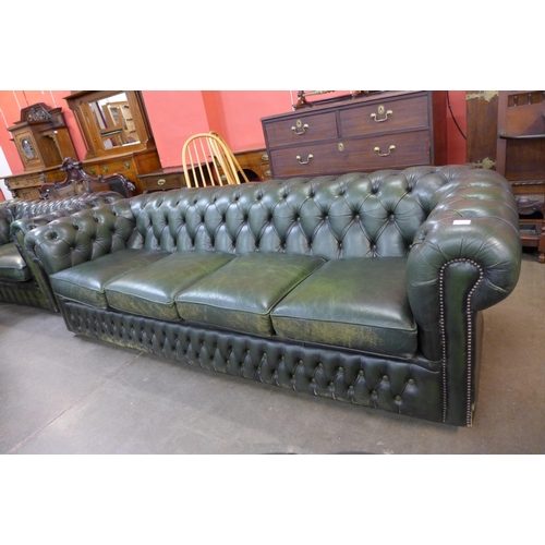 26 - A green leather Chesterfield three piece suite, comprising; four seater settee and two club chairs