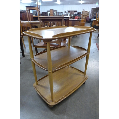 59 - An Ercol Blonde elm and beech Windsor trolley