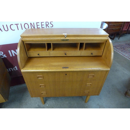 64 - A Swedish SMI teak cylinder bureau, designed by Egon Ostergaard