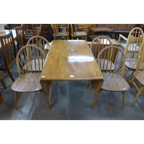 67 - An Ercol Blonde elm and beech drop leaf table and four Windsor chairs