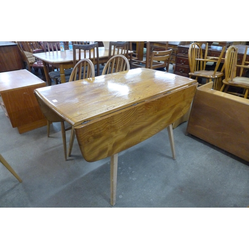 67 - An Ercol Blonde elm and beech drop leaf table and four Windsor chairs