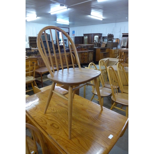 67 - An Ercol Blonde elm and beech drop leaf table and four Windsor chairs